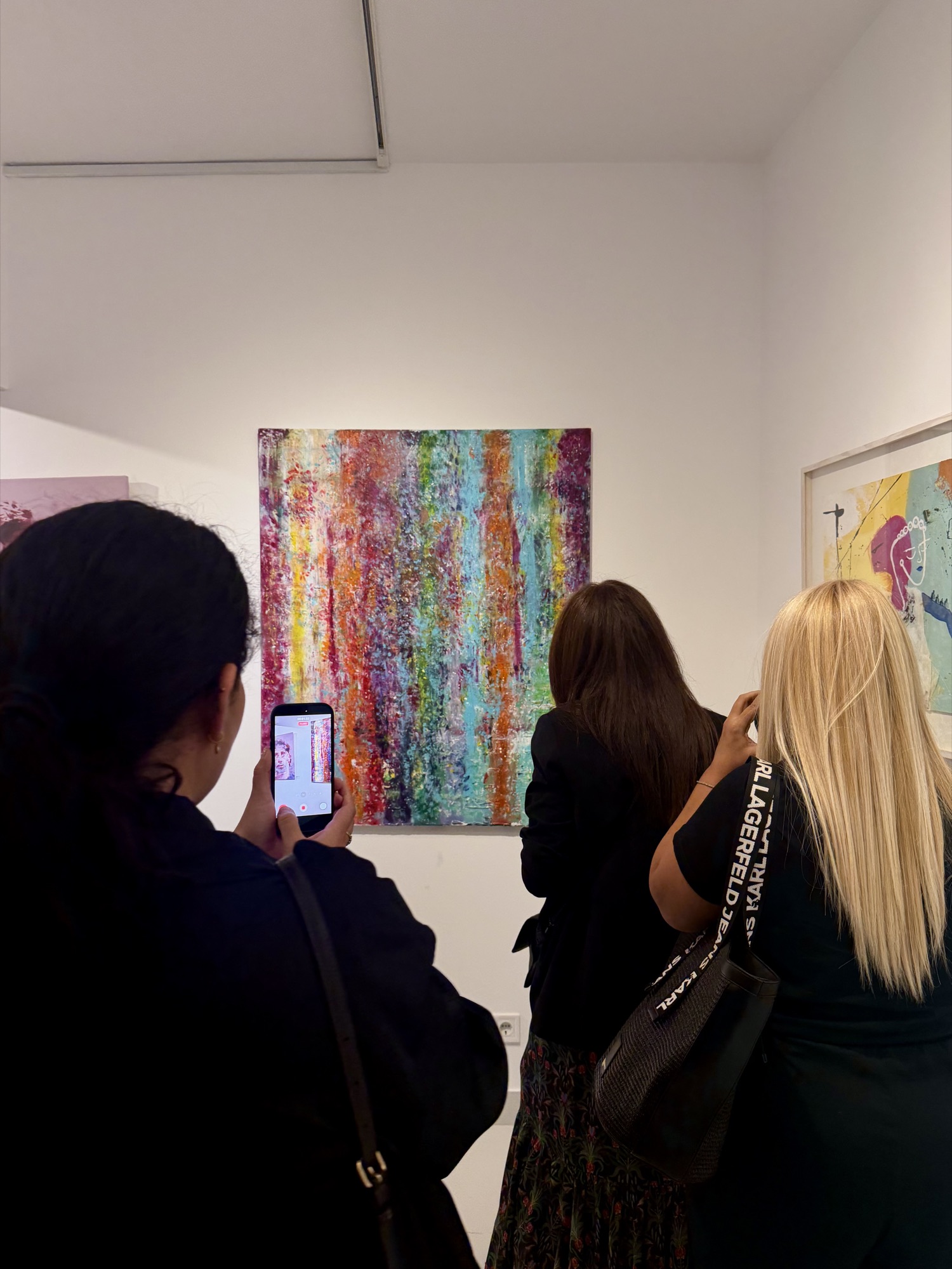 Visitors in front of Sydal's painting at the opening.